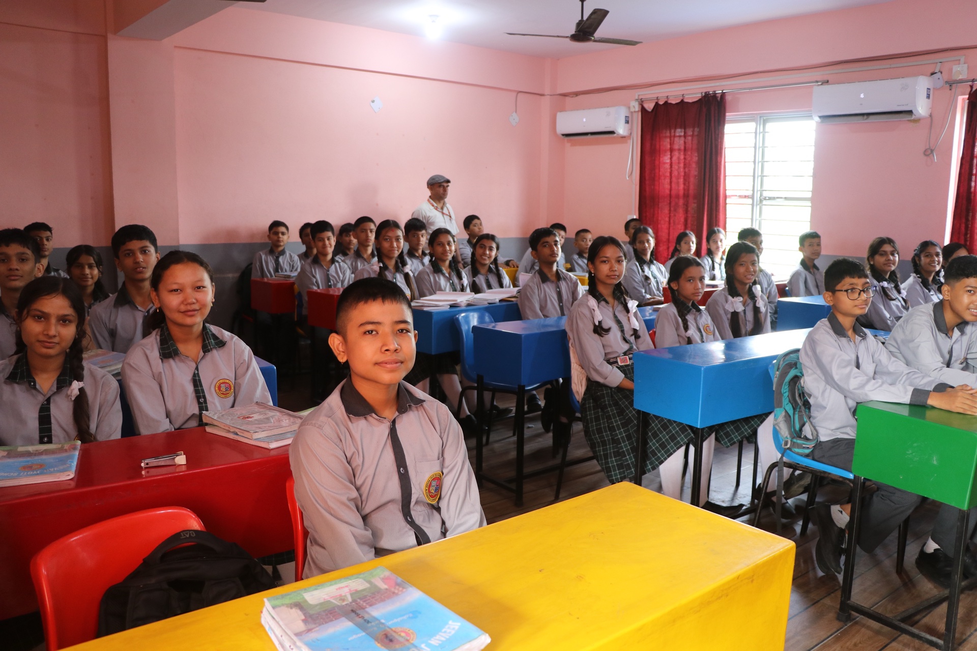 Secondary school students with textbooks and notebooks