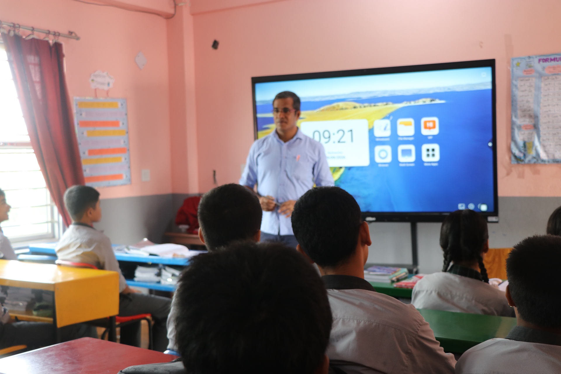 Teacher presenting lesson on interactive digital board
