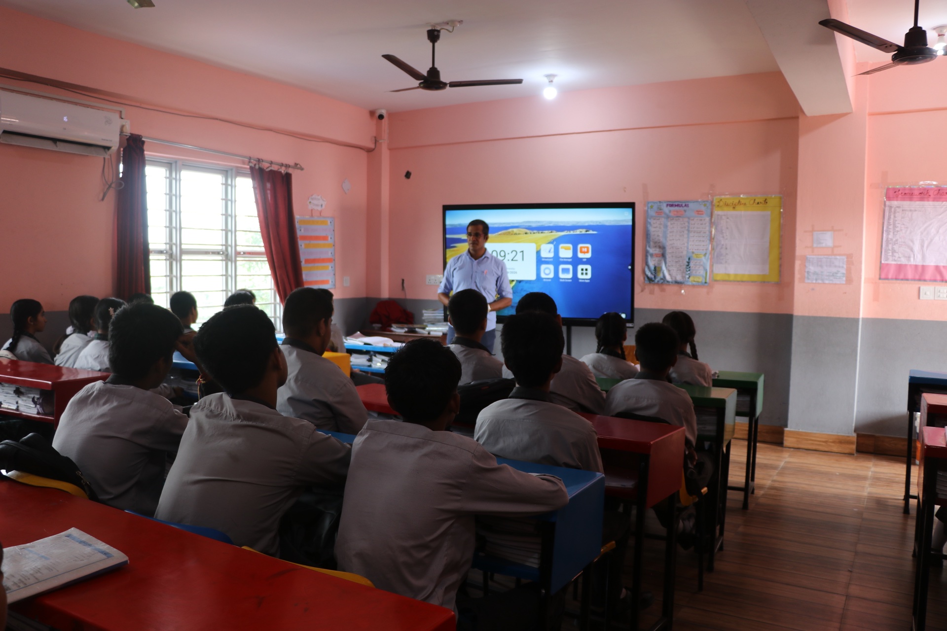 Teacher conducting multimedia lesson on digital smart board