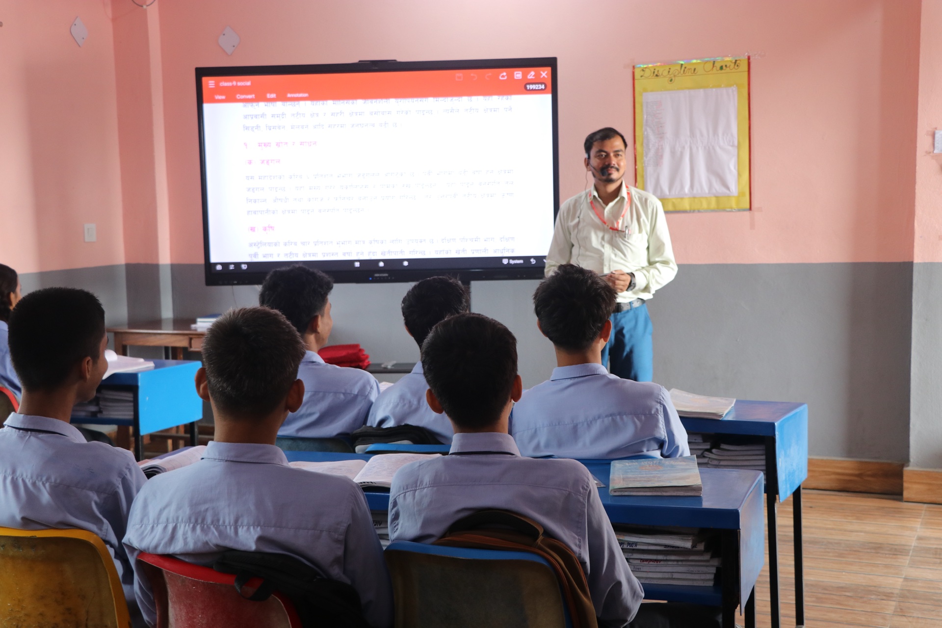 Teacher delivering curriculum on large touchscreen panel