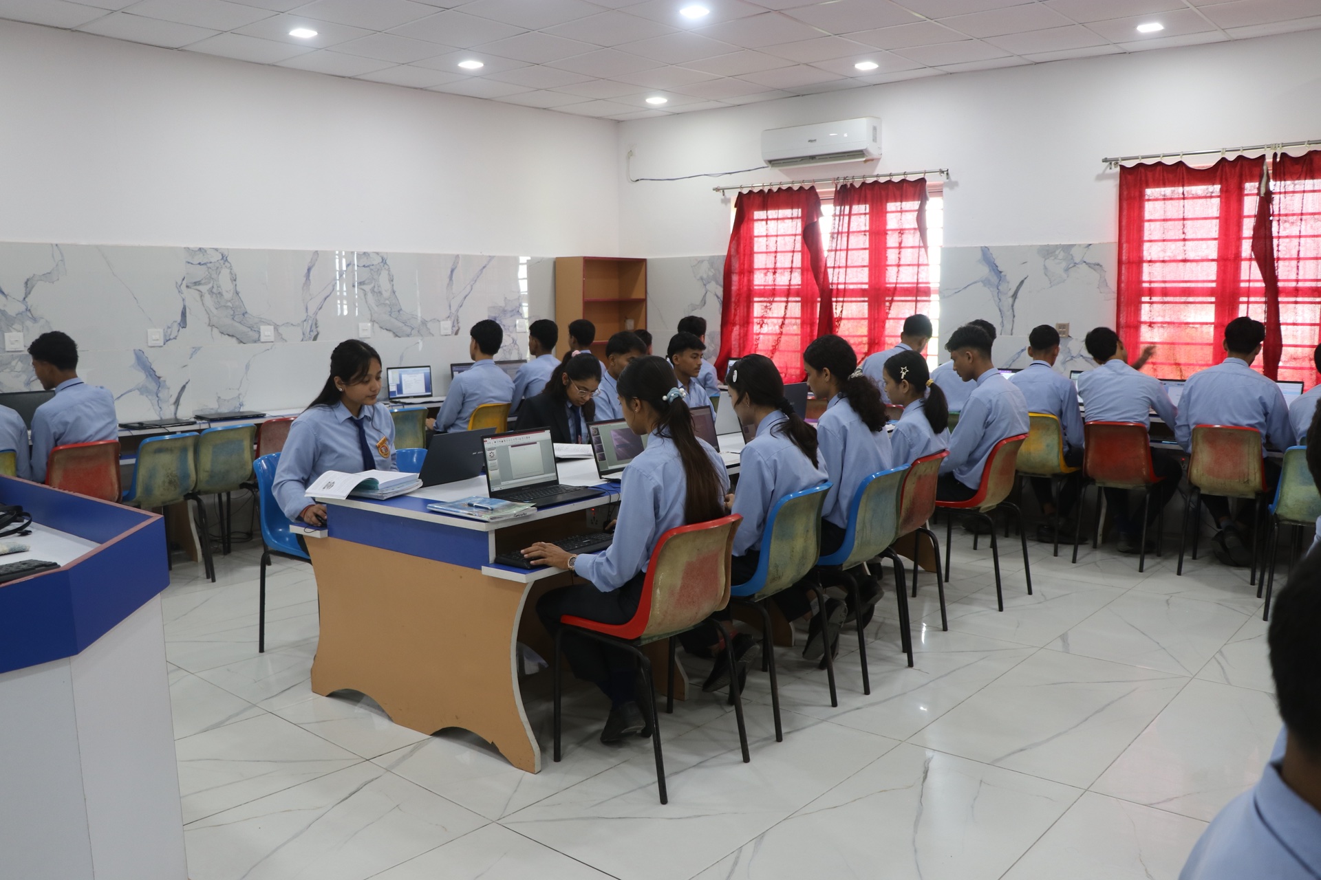 Senior students working on computers in modern IT lab