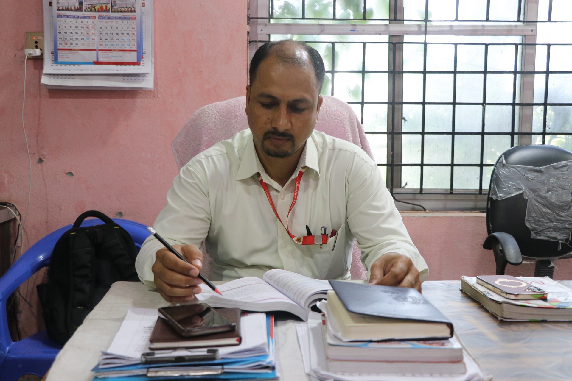 Faculty member preparing lesson plans and student curriculum