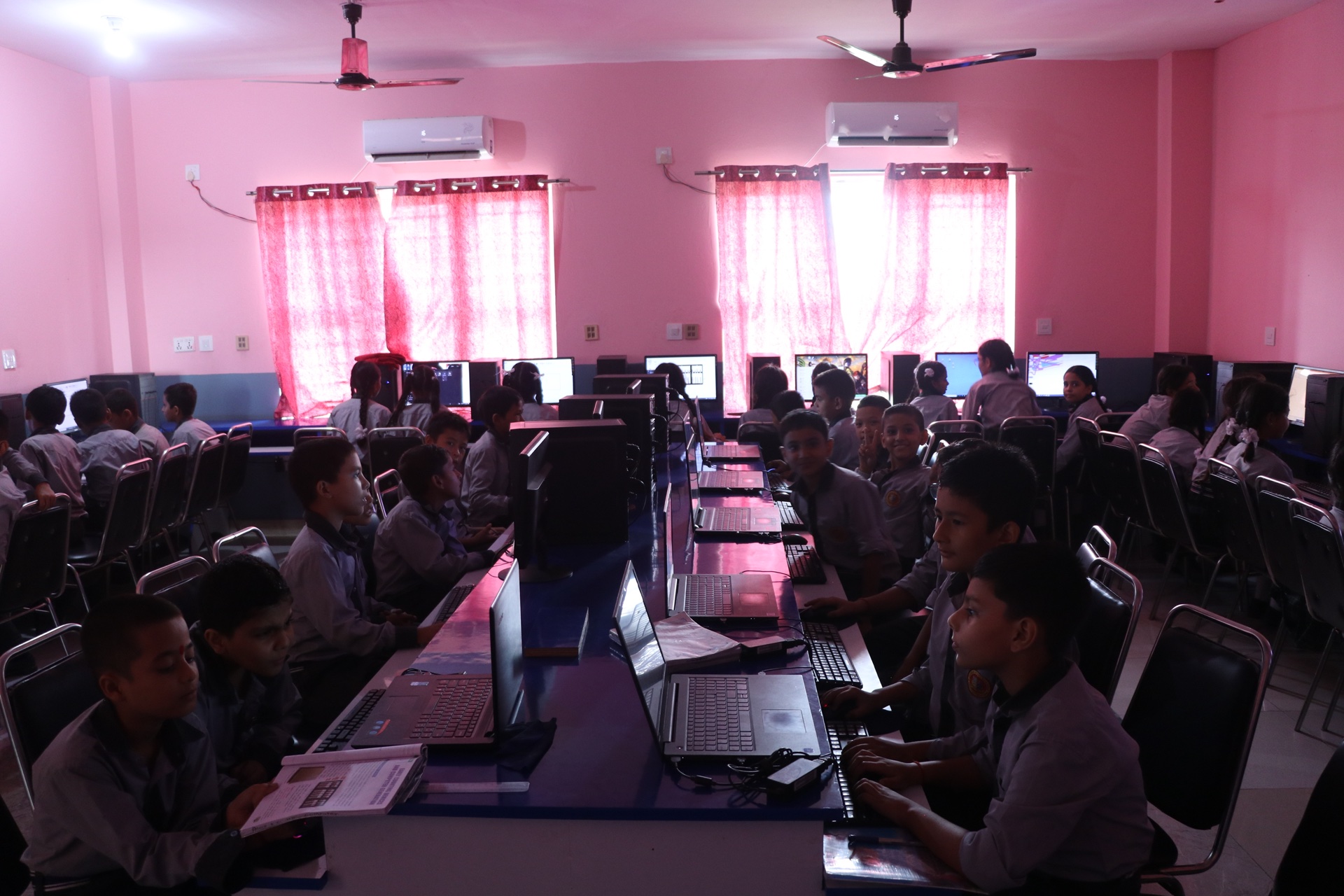 Younger students engaged in computer lab training