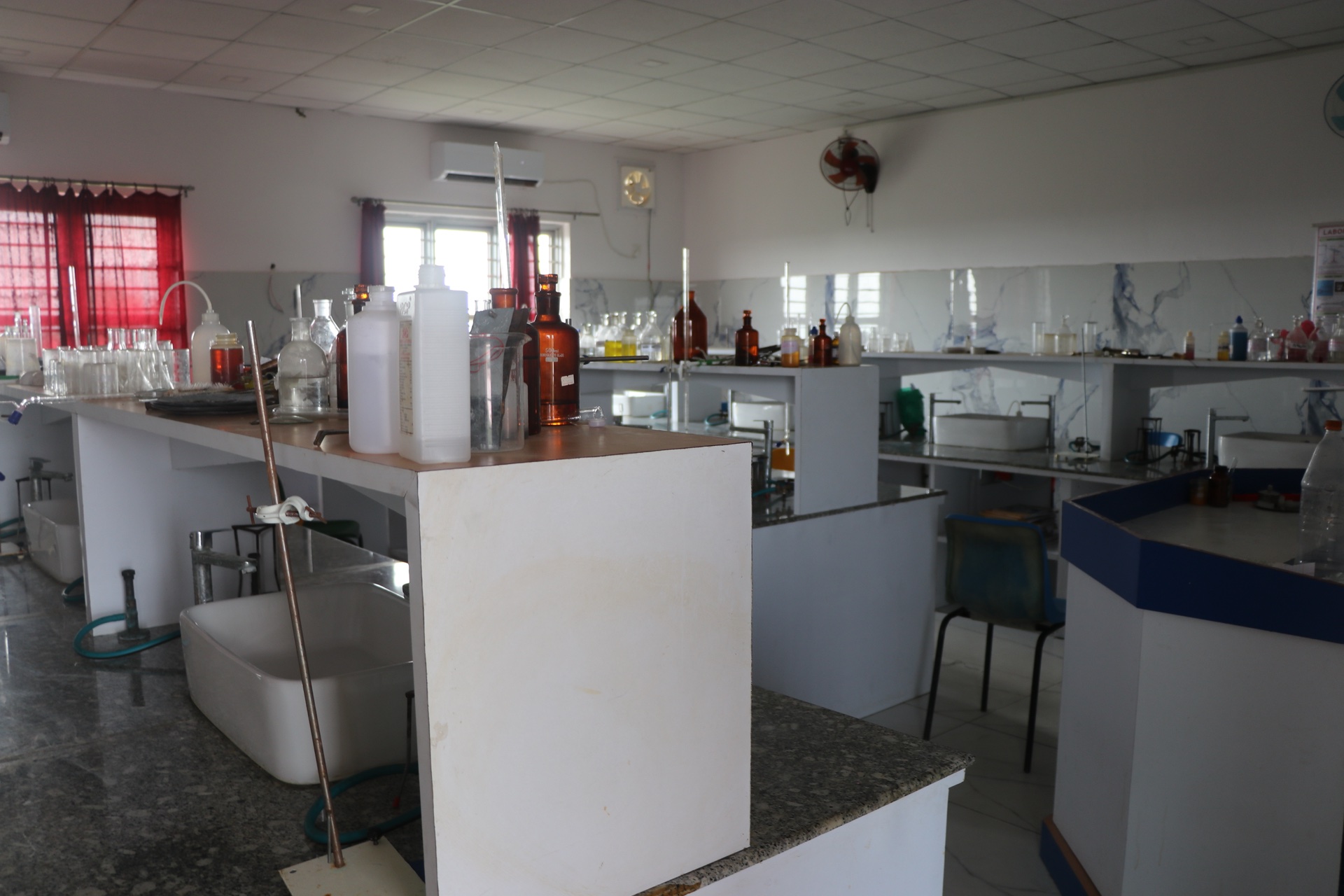 Chemistry laboratory with reagent bottles, glassware and sinks