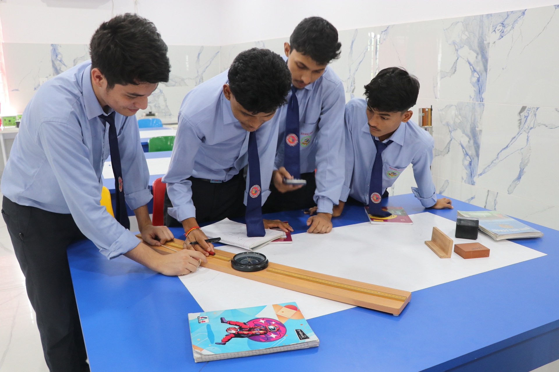 Senior students conducting physics deflection magnetometer experiment