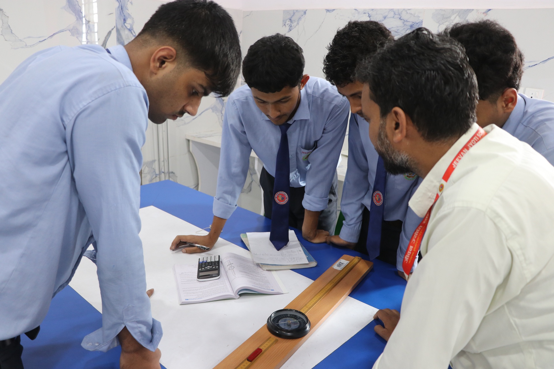 Students recording experimental data in lab notebook