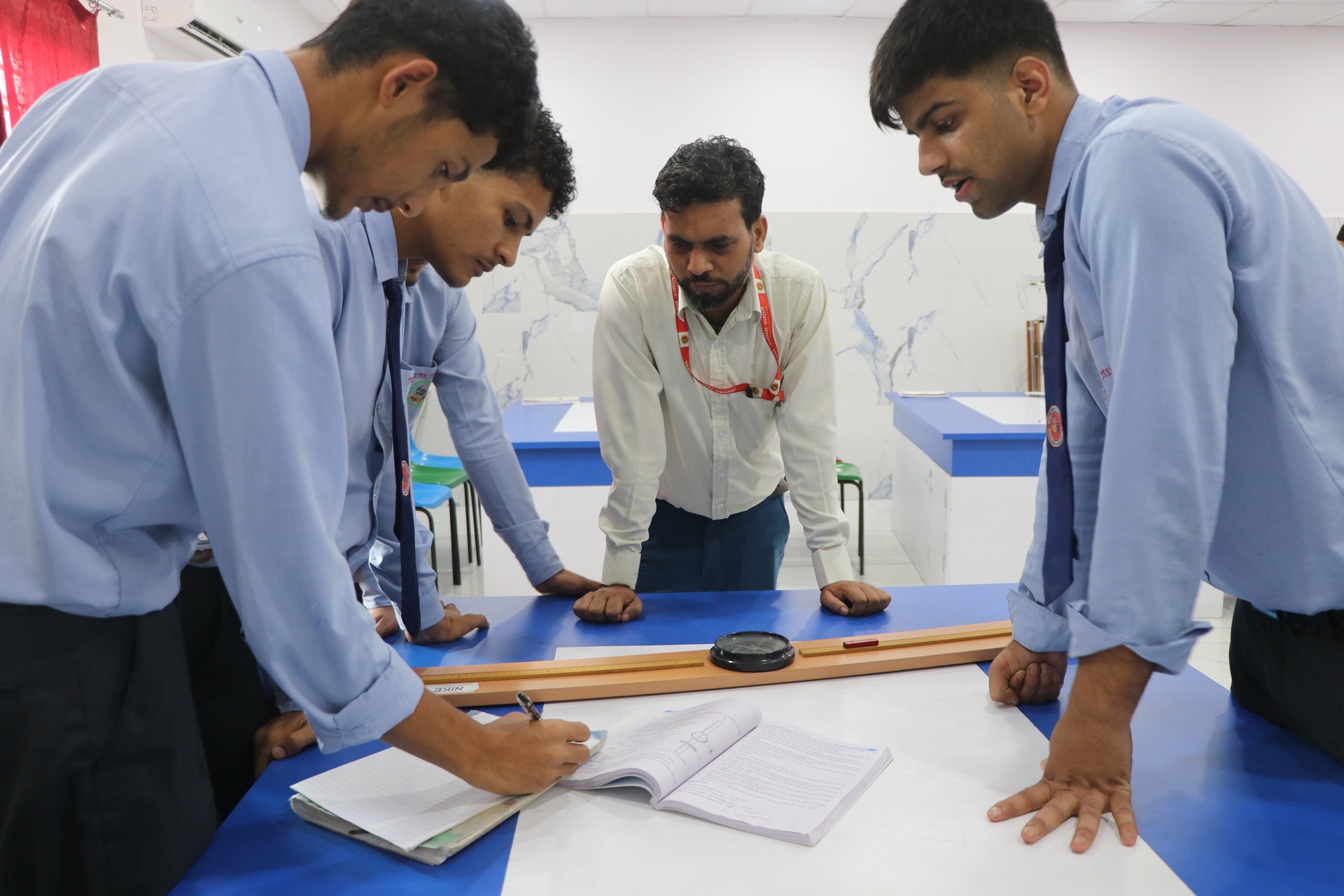 Science teacher guiding students through laboratory experiment
