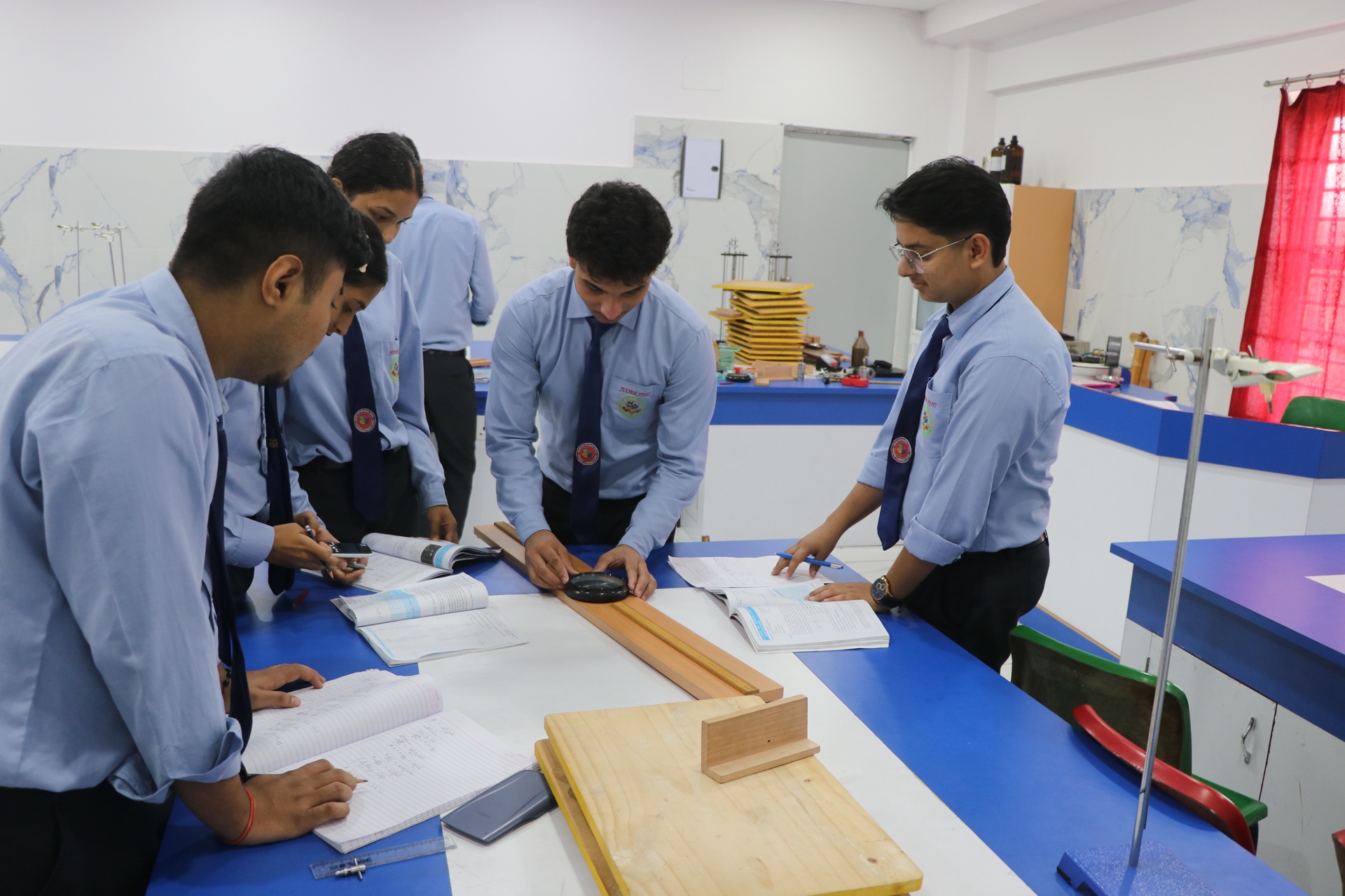 Students verifying scientific laws with lab apparatus