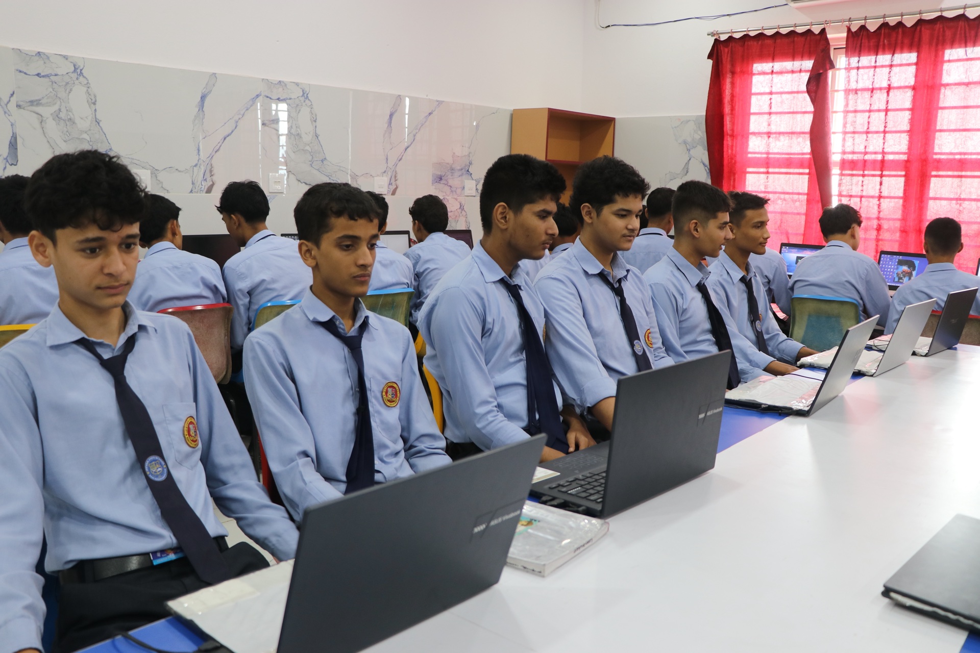 Students in school uniform practicing computer applications